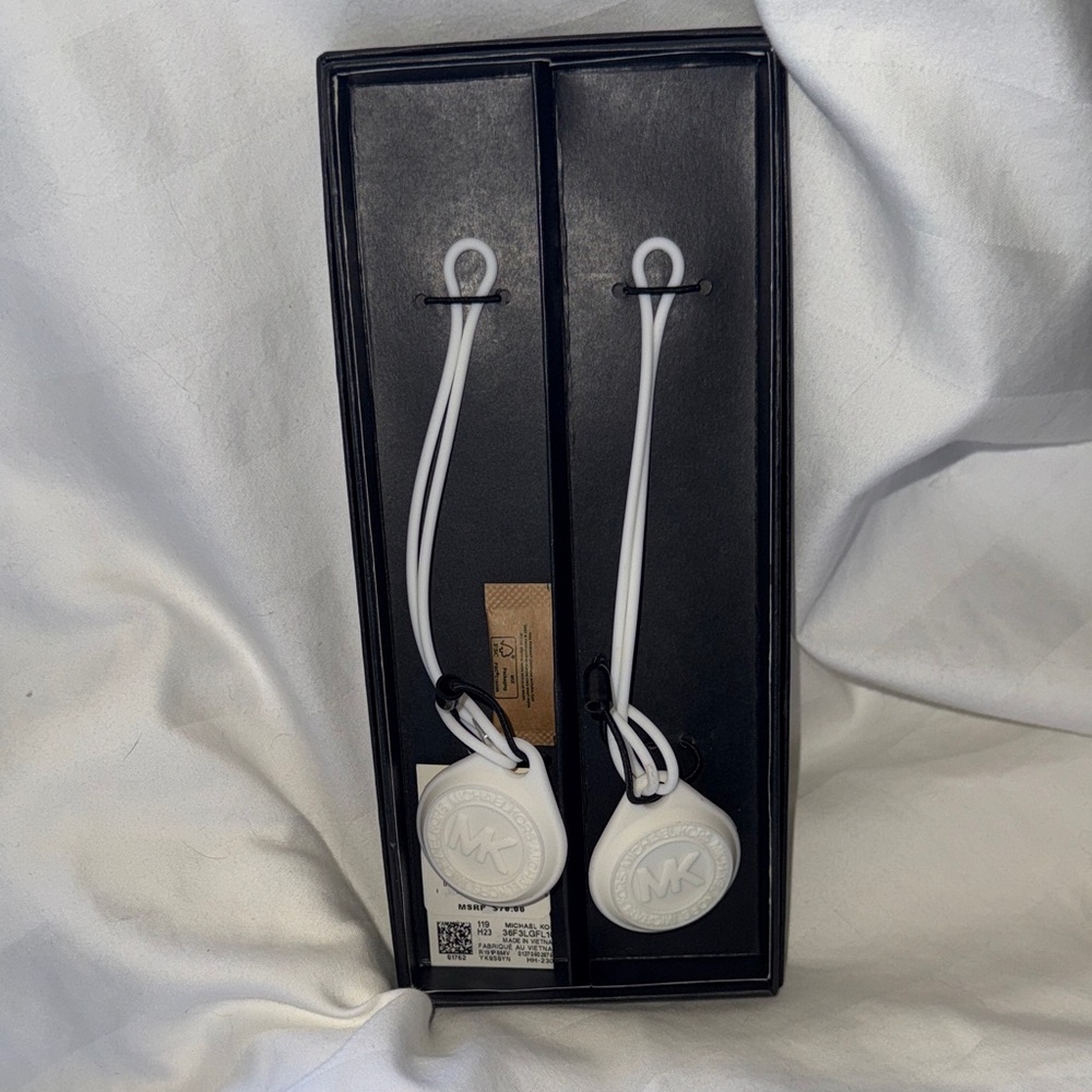 NWT Michael Kors - the tag says for (2) air tag covers,however……